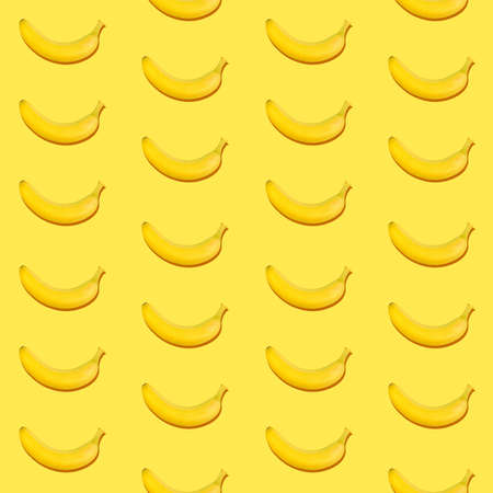 Seamless pattern of fresh ripe yellow bananas on yellow backgroundの写真素材