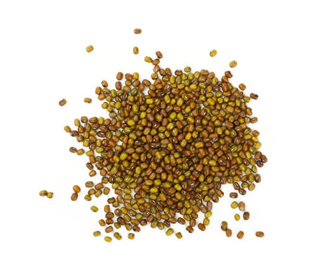 Close up heap of green and brown dried Asian traditional mung (moong) gram beans isolated on white...