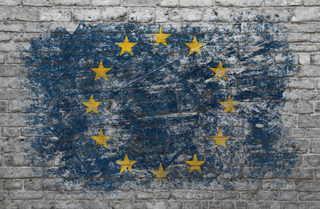 Grunge distressed flag of EU, European Union, painted on old weathered grey brick wall