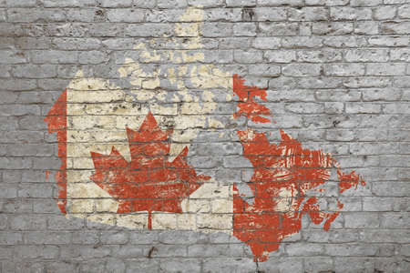 Grunge distressed map shaped flag of Canada painted on old weathered grey brick wallの写真素材
