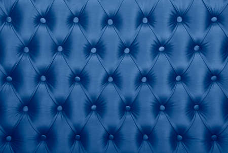 Dark blue capitone textile background, classic retro Chesterfield style checkered soft tufted fabric furniture diamond pattern decoration with buttons, close upの写真素材