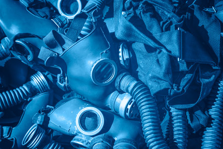 Close up blue toned background of old vintage classic protective gas respirator masks on retail displayの写真素材