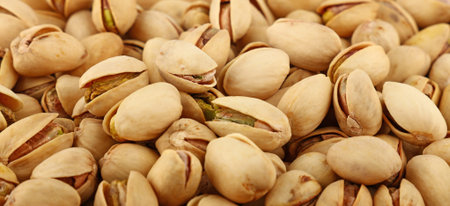 Background texture of fresh roasted pistachio nuts, elevated, high angle top view