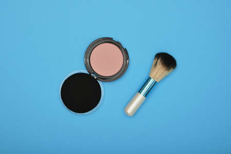 Close up set of face makeup blush, sponge and brush over blue background, elevated top view, directly aboveの写真素材