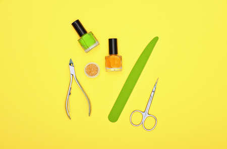 Close up feminine hygiene, beauty, nail care and manicure set on yellow background, elevated top view, directly aboveの写真素材