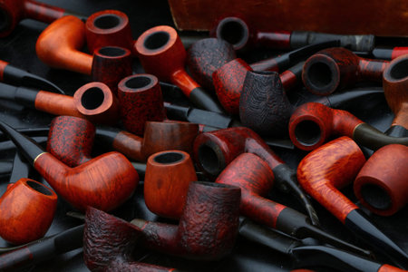 Close up many natural wooden tobacco smoking pipes on market stall, high angle view