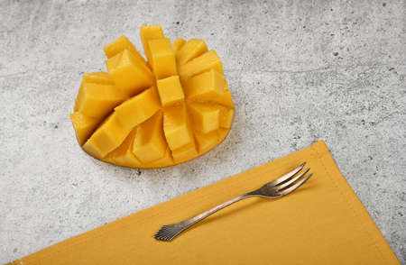 Close up serving fresh ripe cut mango dessert on gray stone table, elevated top view, directly aboveの写真素材