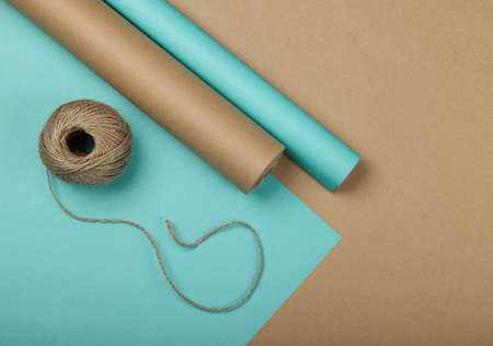 Close up packing and wrapping gifts with blue and brown paper, table top view, flat layの写真素材