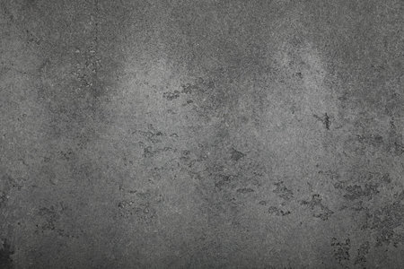 Dark gray grunge uneven concrete surface background texture