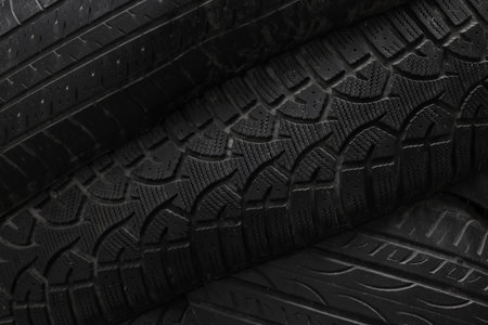 Old used black car or truck wheel tires backgroundの写真素材