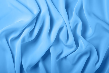 Close up abstract textile background of pastel blue folded pleats of fabric, elevated top view, directly aboveの写真素材