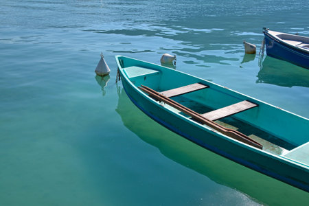 Close up empty pleasure launch boats in turquoise lake water, high angle view, sunny day in Annecy, Franceの写真素材