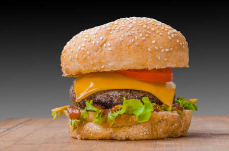 Tasty cheeseburgers with lettuce; beef; double cheese and ketchup. Shallow focus.の写真素材