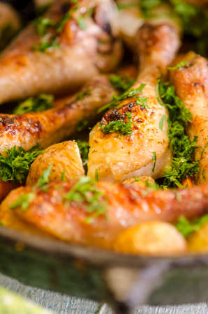 Crisp-tender chicken baked  with roasted carrots and potatoes, shallow focusの写真素材