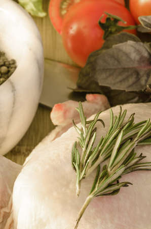 Row chicken with vegetables and spice on wooden tableの写真素材