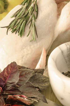 Row chicken with vegetables and spice on wooden tableの写真素材