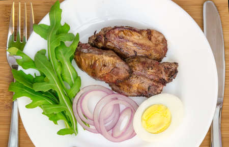 Roasted chicken liver with vegetable on wooden backgroundの写真素材