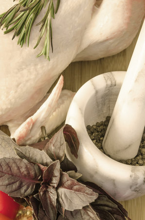 Row chicken with vegetables and spice on wooden tableの写真素材