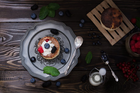Ukrainian cheesecake with berries and cream, still life