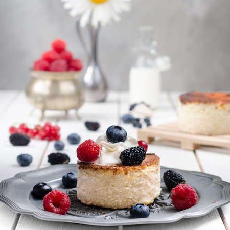 Ukrainian cheesecake with berries and cream, still lifeの写真素材