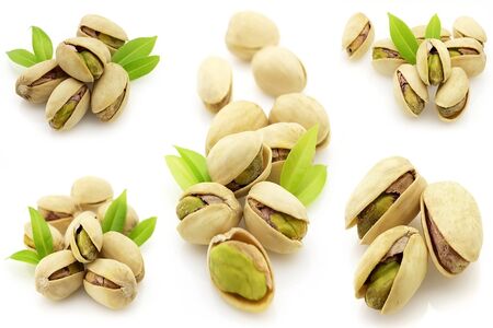 Pistachios with leaves on a white backgroundの写真素材