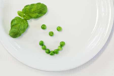 Green vegetable on white plateの写真素材