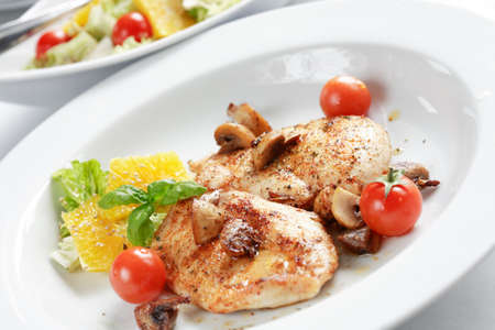 Delicious chicken steak with salad and mushroomsの写真素材