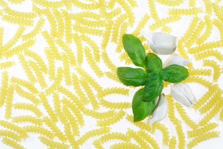 Pasta background with basil and garlicの写真素材