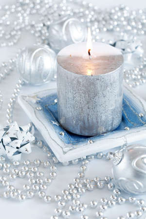 Festive candle as Christmas motive in silver and white tonesの写真素材