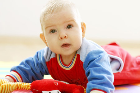 Portrait of small cute baby on bright backgroundの写真素材