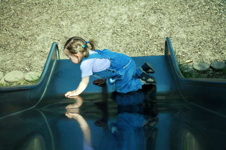 little girl playing at the playgroundの写真素材