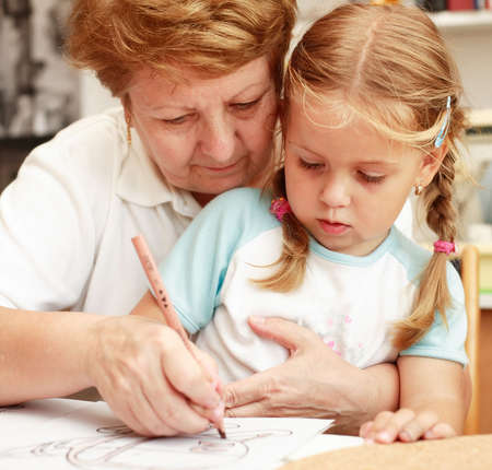 Grandma and grand-daughter paintingの写真素材