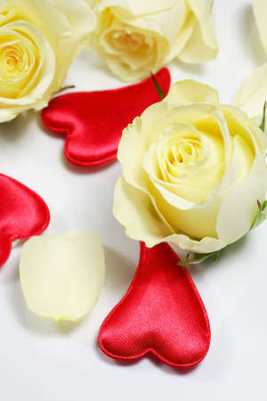 Red hearts and yellow roses on white backgroundの写真素材