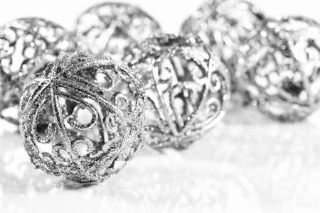 Silver balls on white background with small reflectionの写真素材