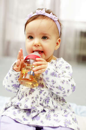 Cute baby is drinking teaの写真素材