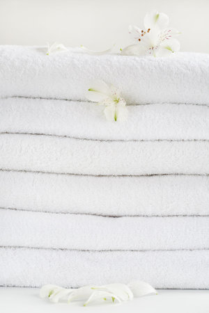 White towels decorated with white flowers for wellnessの写真素材