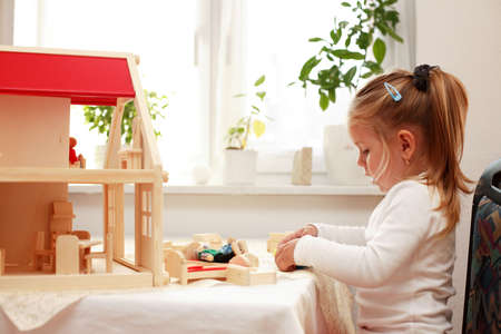 Playing with doll's houseの写真素材