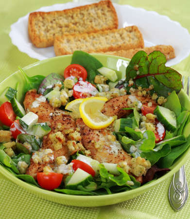 Green mixed salad with chicken stripes and croutonsの写真素材