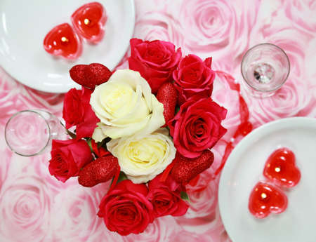 Table setting with rose bouquet for Valentineの写真素材