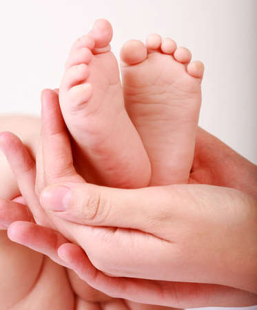 Detail of newborn's feet in mother's hands - shallow DOFの写真素材