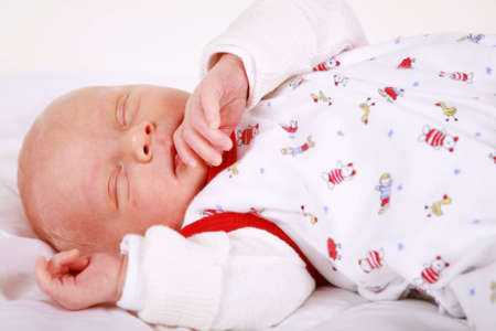 Cute newborn is sleeping peacefullyの写真素材