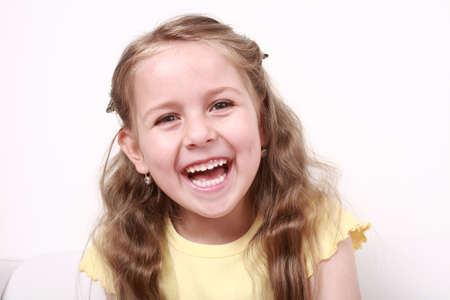 Beautiful small girl is laughing  sincerely の写真素材