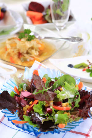 Delicious vegetarian menu - cabbage soup with mixed salad and fresh fruitsの写真素材