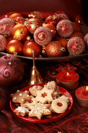Detail of delicious Christmas cookies with candles in red toneの写真素材