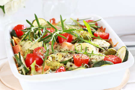 Baked mixed vegetable with cheese and herbsの写真素材