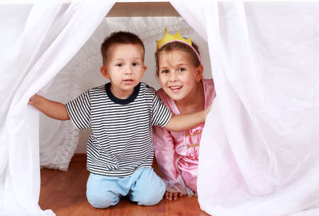 Adorable kids playing hide-and-seek at homeの写真素材