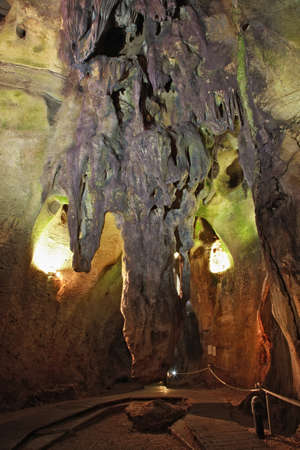 Natural caves in Benidoleig, located in Costa Blanca, Spain -  the cave was inhabited primarily 100,000 years ago by Palaeolithic man. The first explorers found 12 skeletal bodies in 1768. This gruesome discovery gave the caves the name it has today - Calの写真素材