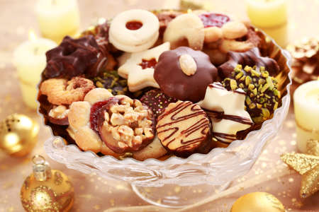 Detail of delicious Christmas cookies with candles in golden toneの写真素材