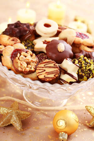 Detail of delicious Christmas cookies with candles in golden toneの写真素材