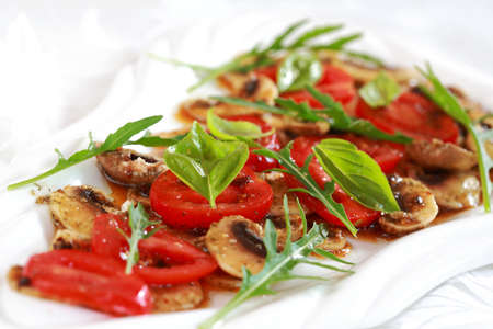 Champignon Carpaccio with marinated tomato and rucola saladの写真素材